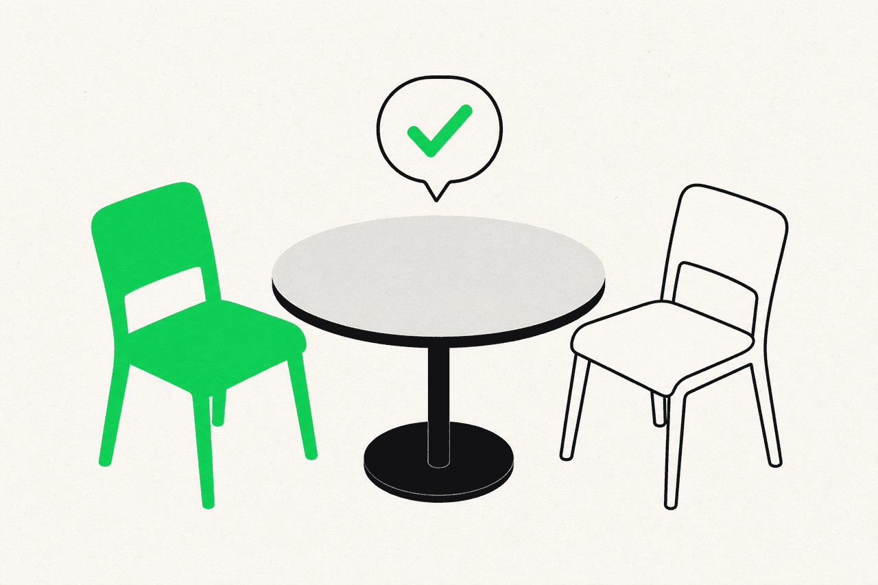 Two chairs at a table, one green and one outlined, with a checked speech bubble above